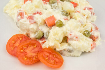 Homemade olivier salad on white plate