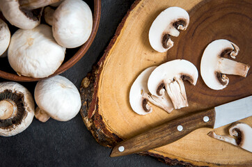 Fresh sliced white mushrooms on cutting board