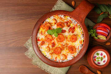 Prawn or shrimp biryani,  Fish biryani. Spicy and delicious Malabar biryani or Hydrabadi biryani, Dum Biriyani, pulao basmati rice, herbs, raitha for Ramadan Kareem, Eid.  Indian food