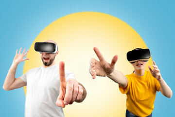 Naklejka premium People wearing virtual reality glasses reach for a virtual object with their hands. Blurred. Blue background with a yellow circle. The concept of virtual reality and modern technologies