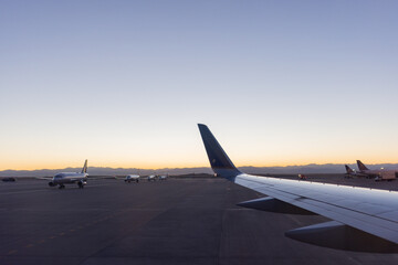 Fototapeta na wymiar Beautiful dawn blue sky over parked planes at the airport