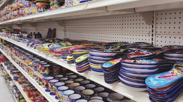 Traditional dishes for sale at a Mexican shop in a border town by the south Texas border. Mexican Colorful Art craft, touristic souvenirs market. Daylight, bright and happy atmosphere.