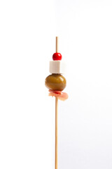isolated Canape with cheese, olive and serrano ham