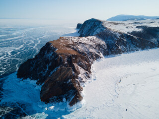 bird's-eye view of the northern tip of Olkhon Island, Cape Khoboy. Travel on the winter lake Baikal Siberia Russia.