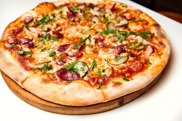 Fresh pizza pickles, bacon, sausages and cheese on a wooden board. Close-up, selective focus
