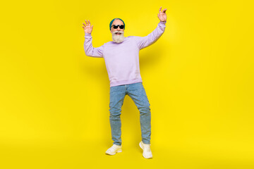 Photo of cheerful cute age gentleman wear violet sweater headwear dark glasses smiling dancing isolated yellow color background