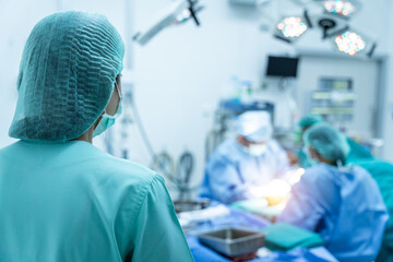 assistant or staff of Team surgeon at work in operating room. - obrazy, fototapety, plakaty