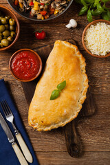 Italian calzone with mushrooms and ham. Top view.