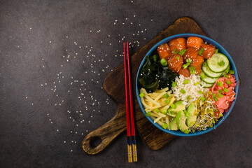 Hawaiian salmon poke bowl with seaweed, avocado, sesame seeds.