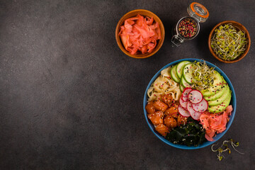 Hawaiian salmon poke bowl with seaweed, avocado, sesame seeds.