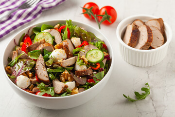 Salad with pork tenderloin, fresh cucumber and mozzarella.