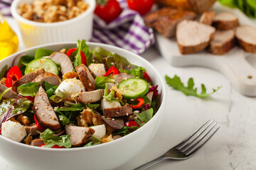 Salad with pork tenderloin, fresh cucumber and mozzarella.