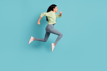 Fototapeta na wymiar Full size profile portrait of excited lady jumping running look empty space isolated on blue color background