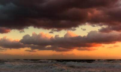 Cloudy sunset at the stormy sea.
