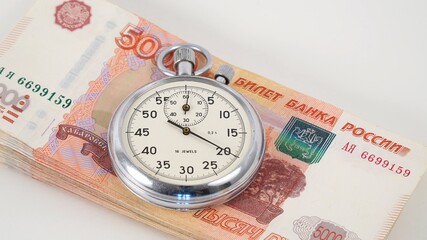 Stopwatch on a wad of Russian money.
