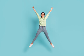 Fototapeta na wymiar Full length body size view of pretty carefree glad cheerful girl jumping having fun isolated over bright blue color background