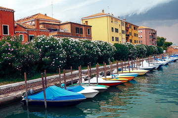 Row of moored boats . Coastal residential district in Venice 
