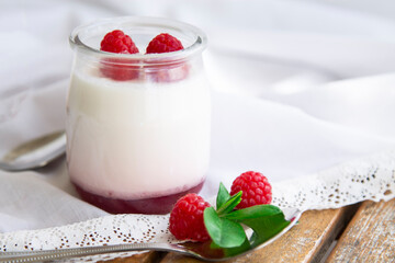 Greek yogurt with raspberries in glass jars