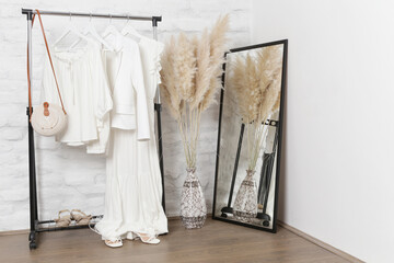 Women's fashion. Summer white clothes made from natural viscose and cotton fabrics in fashion atelier.