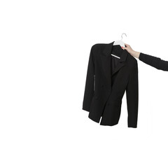 Black double-breasted blazer hanging on a coathanger isolated on white background. Modern premium quality hand made woman's fashion.