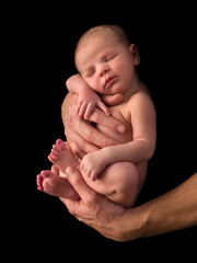 Newborn baby in hands