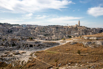 Panoramic view of Sassi di Matera a historic district in the city of Matera, well-known for their ancient cave dwellings from the Belvedere di Murgia Timone,  Basilicata, Italy