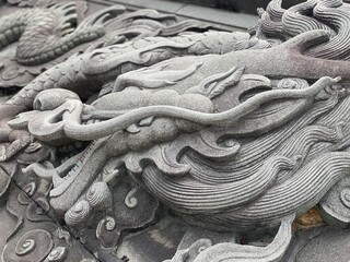 Marble carved into a beautiful dragon, Historic stone engraving. Viking snake, Dragon stone carved statue on stone for statue. Chinese zodiac animal sculpture. Traditional asian art for travel in Asia