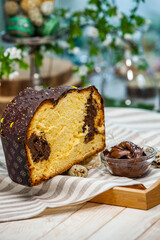 Panettone is the traditional Italian dessert for easter in 2021. Homemade panettone covered in chocolate. Sweet Bread served as dessert.