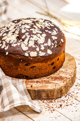 Panettone is the traditional Italian dessert for easter in 2021. Homemade panettone covered in chocolate. Sweet Bread served as dessert.