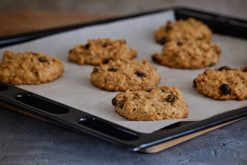 Oatmeal cookies from the oven on the grid on the gray table