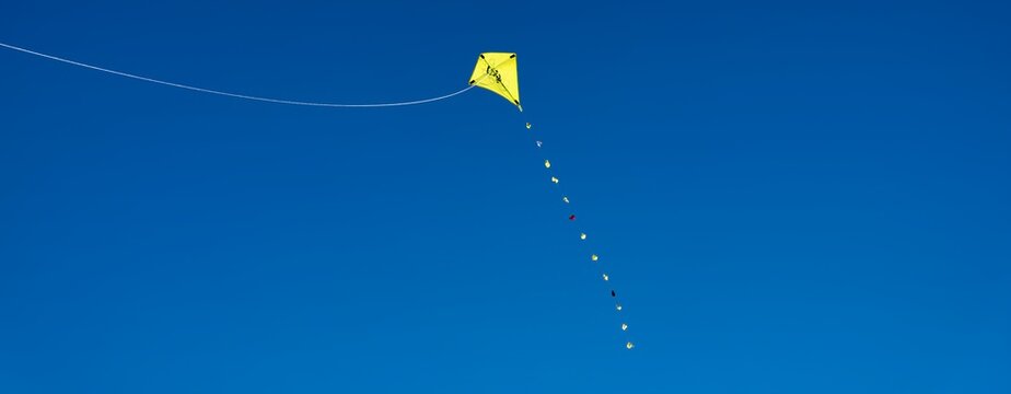 yellow kite in the blue sky