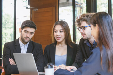 Amazed, Smiling business people group,teamwork of young asian,caucasian having fun, happy in workplace after project is done,win while looking at screen computer on laptop.Celebrating success concept.