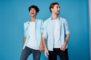 friends in unbuttoned shirts and white t-shirts jeans blue background fun communication party