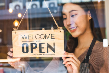 Smiling asian young business owner, employee retail,coffee shop woman,girl turning,setting sign...