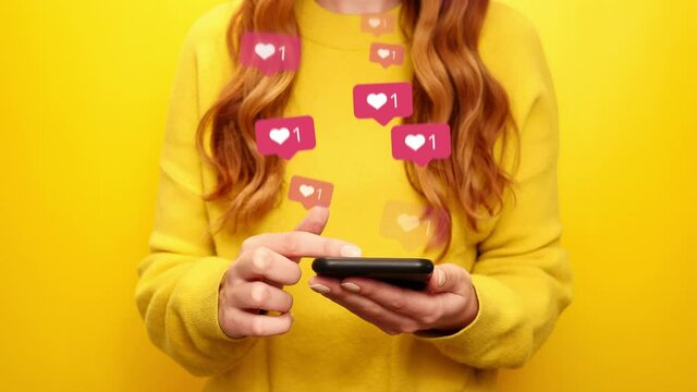 Young girl receive likes using phone social media network application. Animation like icons. Social, love, success, influencer concept animation on yellow background