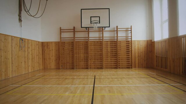 Empty school gym. Classic design of 70 years. Wooden parquets and ladders on the walls.