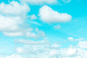 Naklejka na ściany i meble Teal blue sky with scenic white clouds, a windy day