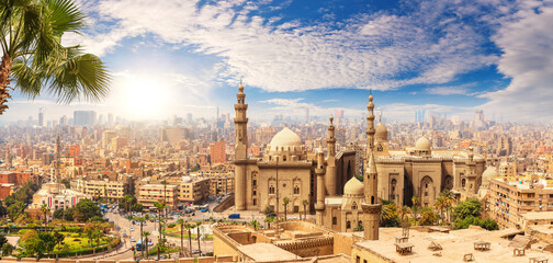 Famous Mosque of Sultan Hassan behind the palm tree, Cairo skyline, Egypt - obrazy, fototapety, plakaty