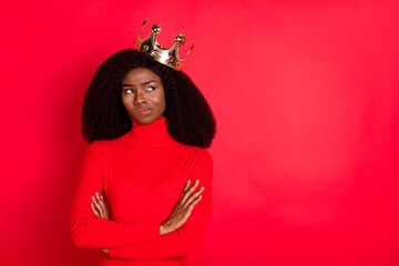 Photo of young african woman wear golden crown unhappy sad doubt crossed hands isolated over red color background