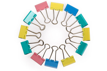 Top view of multi colored binder clips laid out circle