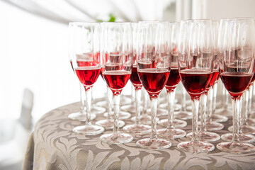a pile of pink champagne glasses on a table ready to serve. glasses of cava