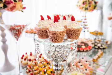 Obraz na płótnie Canvas different desserts on a candy bar at a banquet.assorted tartlets