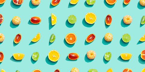 Summer fruits top view, bright juice citrus, lemon, orange, tangerine and lime on blue background. Healthy fruit food.