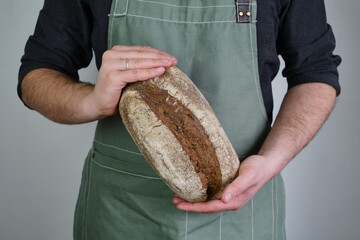 Crispy fresh bread in the hands of a man. Rustic organic wheat bread. Gluten free. Home baking...