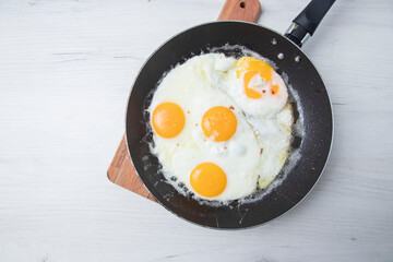 Scrambled eggs in frying pan . National Ukrainian or belorussian food. Breakfast, lunch. Top view, selective focus, rustic style.