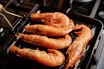 Grilled large shrimps with lemon and spices on the grill pan