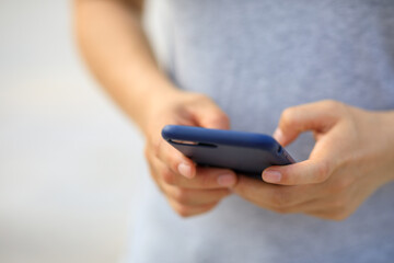 Asian woman using smartphone outdoors