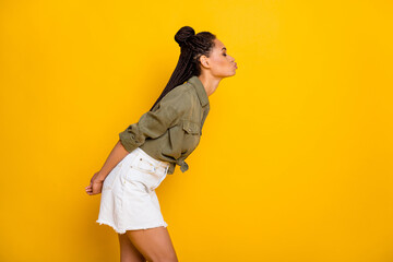 Photo portrait side view of girl leaning in for a kiss isolated on vivid yellow colored background...