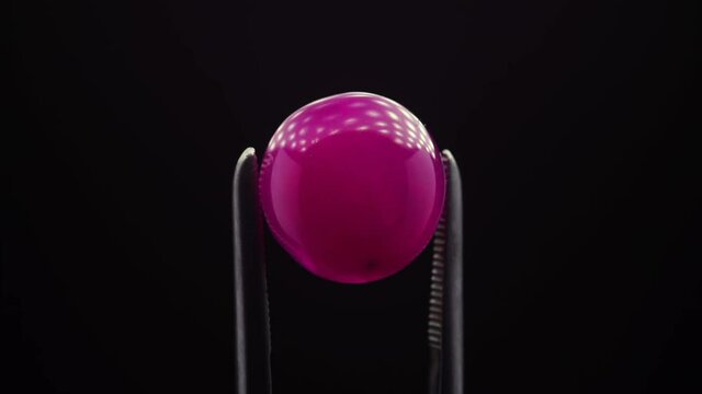 natural red rhodolite gemstone on the turning table