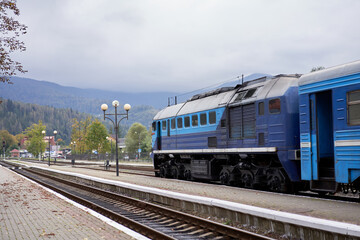 Fototapeta na wymiar Train stands o platform railway station small provincial town Rural transportation train